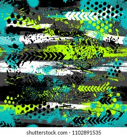 Abstract seamless grunge pattern. Textured cracked repeated backdrop for boy, sport clothes, wrapping paper, textile.  Lines elements, triangles, arrows in bright blue, green, black colors.