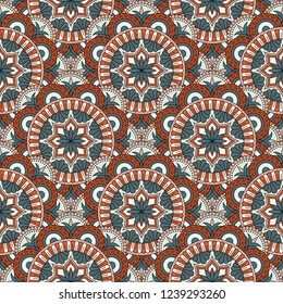 Abstract seamless mandala background. Texture in blue and orange colors. Oriental pattern for design, fashion print, scrapbooking