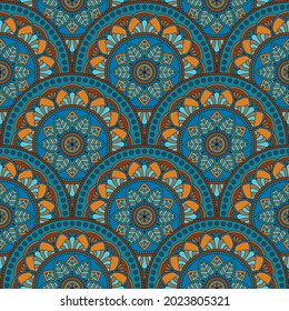 Abstract seamless mandala background. Texture in blue and orange colors. Oriental pattern for design, fashion print, scrapbooking