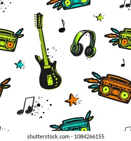 Abstract seamless music pattern. Electro guitar, record player, notes, headphones, stars, lightning, spray paint ink. Grunge teenagers repeated backdrop. Colorful mysical instrument wallpaper