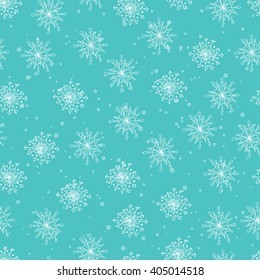 Abstract seamless pattern background with white snow, hand drawn snowflakes. Imitation of snowfall, blizzard or snowstorm on blue sky background. Design for fabric or wrapping paper. Christmas theme.