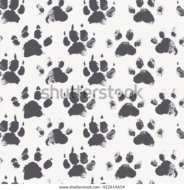 Abstract seamless pattern - black ink prints\
with messy dog paws. Creative monochrome backdrop with regular\
animal footprints