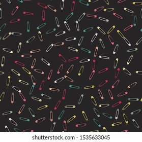 Abstract, seamless pattern. Colorful pins and matches are randomly scattered on a black background