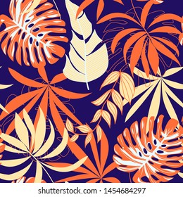Abstract seamless pattern with colorful tropical leaves and plants on purple background. Vector design. Jungle print. Flowers background. Printing and textiles. Exotic tropics. Fresh design.
