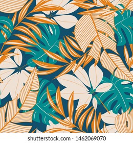 Abstract seamless pattern with colorful tropical leaves and flowers on a pastel background. Vector design. Jungle print. Floral background. Printing and textiles. Exotic tropics. Summer design.