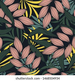 Abstract seamless pattern with colorful tropical leaves and plants on dark background. Vector design. Jungle print. Floral background. Printing and textiles. Exotic tropics. Summer.