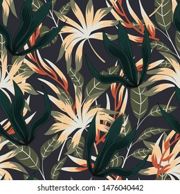 Abstract seamless pattern with colorful tropical leaves and plants on grey background. Vector design. Jungle print. Floral background. Printing and textiles. Exotic tropics. Summer.