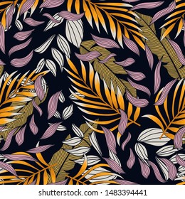 Abstract seamless pattern with colorful tropical leaves and flowers on purple background. Vector design.Exotic tropics. Summer. Jungle print. Floral background. Printing and textiles.