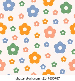 Abstract seamless pattern with colorful vintage groovy daisy flowers on pastel background. Retro vector background in style 60s, 70s