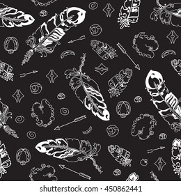 Abstract seamless pattern with feathers and  beads on black background. Hand drawn background for design and decoration textile, covers, package, wrapping paper.