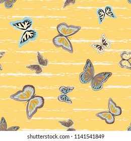 Abstract seamless pattern with flying butterflies on a background of colored stripes. The quadrangular texture of the summer. Vector illustration. Suitable for fabric, wallpaper, packaging.