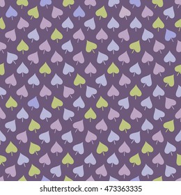 Abstract seamless pattern with green, blue and lilac leaves placed in chaotic order on purple background