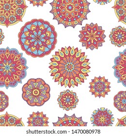 Abstract seamless pattern of hand-drawn mandalas in beautiful colors on white background