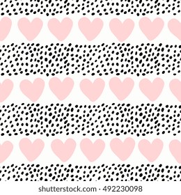 Abstract seamless pattern with hearts and dots in pastel pink and black on white background.