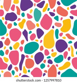 Abstract seamless pattern inspired by dalmatian dog spots and stones. Vector art with sketchy and handmade style. Bold and playful colorful shapes.