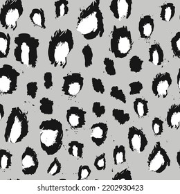 Abstract seamless pattern of leopard skin. black and white irregular brush spots on a gray background. Abstract print of the skin of a. Simple modern fashion design