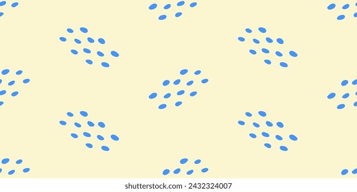 Abstract seamless pattern with light blue drops or dots on yellow background, vector