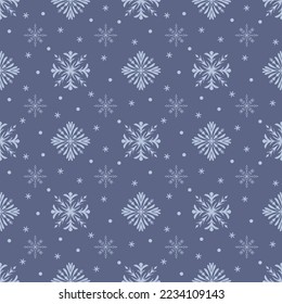 Abstract seamless pattern made of snowflakes on blue.