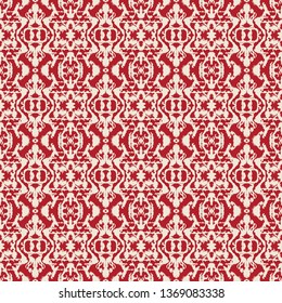 Abstract seamless pattern with mirrored symmetrical, marbled shapes in red and cream.