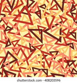 Abstract seamless pattern of orange, pink, red and maroon overlapping triangles chaotic scattered on a light yellow background.