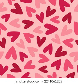 Abstract seamless pattern with pink and red hearts on pink background. Hand drawn doodle style. Great for Valentine's Day, Wedding, Mother's Day. Vector illustration