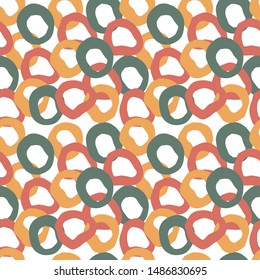 Abstract seamless pattern with random oval shapes in terracotta, yellow and green colours. Imitation chain mail. Hand drawn illustration.