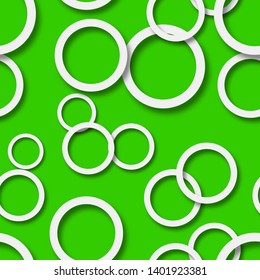 Abstract seamless pattern of randomly arranged white rings with soft shadows on green background
