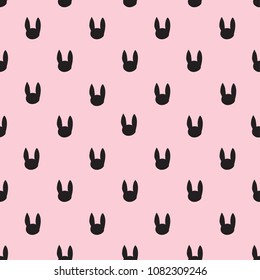 Abstract seamless pattern with silhouette of rabbit on pink color. pattern for textiles, fabric, wrapping paper, children, web, clothing, backpack, bedding.