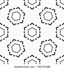 Abstract seamless pattern of six-pointed stars made of triangular shapes. Fashion flat design. Symmetric geometric shapes. Vector background.