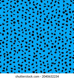 Abstract seamless pattern from small shapes. Simple background of irregular spots. Abstract wild animal skin print. Random spaced black spots. Vector illustration on light blue background
