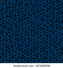 Abstract seamless pattern from small shapes. Simple background of irregular spots. Abstract wild animal skin print. Random spaced black spots. Vector illustration on dark blue background
