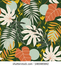 Abstract seamless pattern with tropical leaves and bright colors on green background. Print of the jungle. Vector design. On a floral background. Textiles and printing. Exotic, tropical.