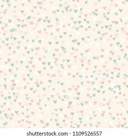 Abstract seamless pattern in vector. Colorful explosion of confetti. Pastel texture with small hand drawn hearts. Valentine’s Day background