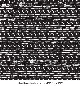 Abstract seamless pattern with white horizontal different sizes zigzag strokes on black background