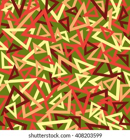 Abstract seamless pattern of yellow, red, pink and maroon overlapping triangles chaotic scattered on a green background.
