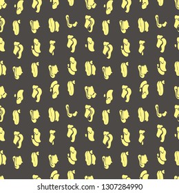 Abstract seamless repeat pattern. Vector illustration of shapes of stylized yellow neon sheep ankle bones on charcoal grey background.
