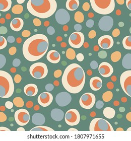 Abstract seamless repeating background of multicolored circles of different shapes