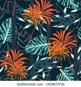 Abstract seamless tropical pattern with bright leaves and plants on a dark blue background. Vector design. Jungle print. Floral background. Printing and textiles. Exotic tropics. Summer design.