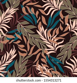 Abstract seamless tropical pattern with bright beige and red plants and leaves on brown background. Seamless pattern with colorful leaves and plants. Exotic jungle wallpaper.