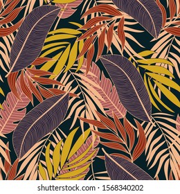 Abstract seamless tropical pattern with bright yellow and red plants and leaves on dark background. Modern abstract design for fabric, paper, interior decor. Beautiful exotic plants. 