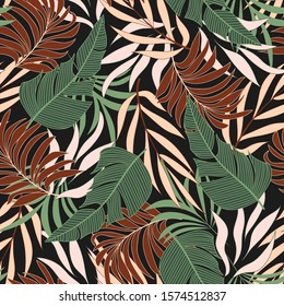 Resumen de un patrón tropical sin fisuras con brillantes plantas borgoñas y verdes y hojas en un fondo oscuro. Diseño exótico sin inconvenientes con plantas tropicales. Hojas tropicales en colores brillantes.