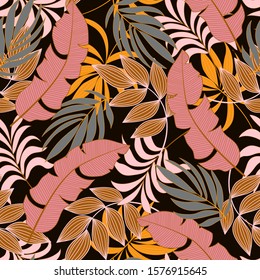 Abstract seamless tropical pattern with bright pink and yellow plants and leaves on brown background. 
Trendy summer Hawaii print. Beautiful print with hand drawn exotic plants.