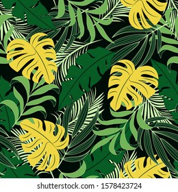 Abstract seamless tropical pattern with bright yellow and green plants and leaves on a dark background. Exotic tropics. Summer.Vector design. Jungle print. Floral background.  