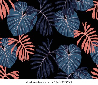 Resumen de un patrón tropical sin fisuras con hojas y plantas coloridas brillantes sobre fondo negro. Diseño exótico sin inconvenientes con plantas tropicales. Papel pintado exótico. Impresión Hawaii de verano de moda.