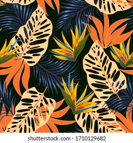 Abstract seamless tropical pattern with bright plants and leaves on a dark background. 
Exotic jungle wallpaper. 
Colorful stylish floral. Vintage pattern.