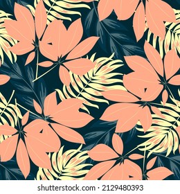 Abstract seamless tropical pattern with bright plants and leaves on a dark blue background. Modern abstract design for fabric, paper, interior decor. Summer colorful hawaiian.