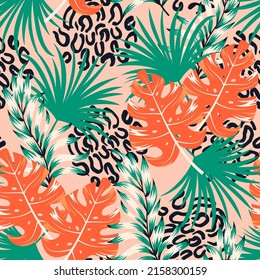 Abstract seamless tropical pattern with bright plants and leaves on a pink background. Tropical botanical. Modern abstract design for fabric, paper, interior decor. Exotic jungle wallpaper.