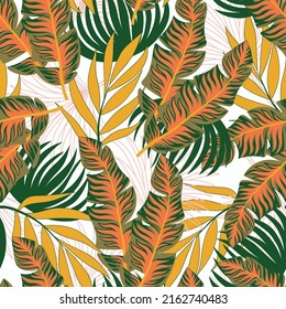 Abstract seamless tropical pattern with bright plants and leaves on a pastel background. Beautiful print with hand drawn exotic plants. Seamless pattern with colorful leaves and plants. 