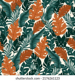 Abstract seamless tropical pattern with bright plants and leaves on the background. Beautiful print with hand drawn exotic plants. Seamless pattern with colorful leaves and plants. 