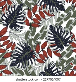 Abstract seamless tropical pattern with bright plants and leaves on a white background. Jungle leaf seamless vector floral pattern background. Exotic jungle wallpaper. Exotic wallpaper.